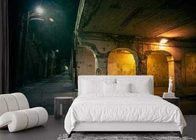 Dark and eerie urban city alley at night  Wall mural